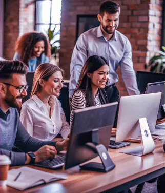 A happy team looking at their monitors
